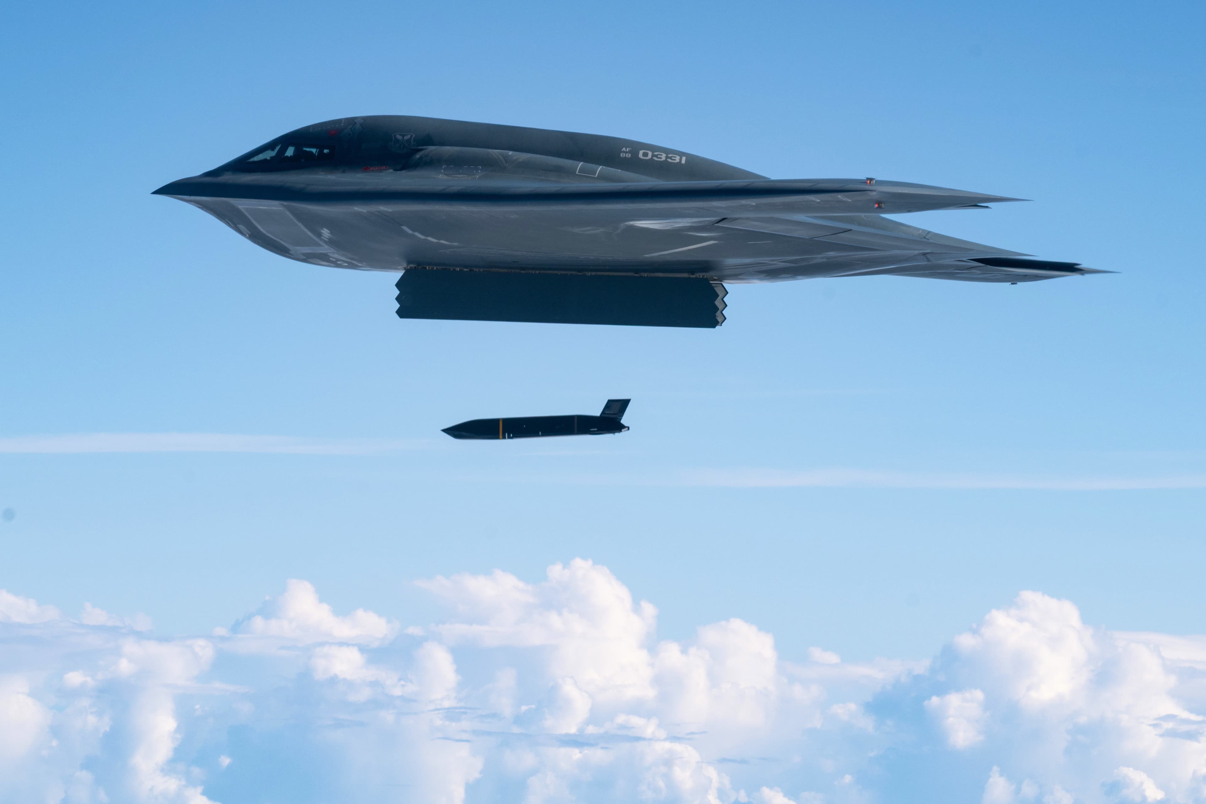 A B-2 Spirit releasing a store above cloud
