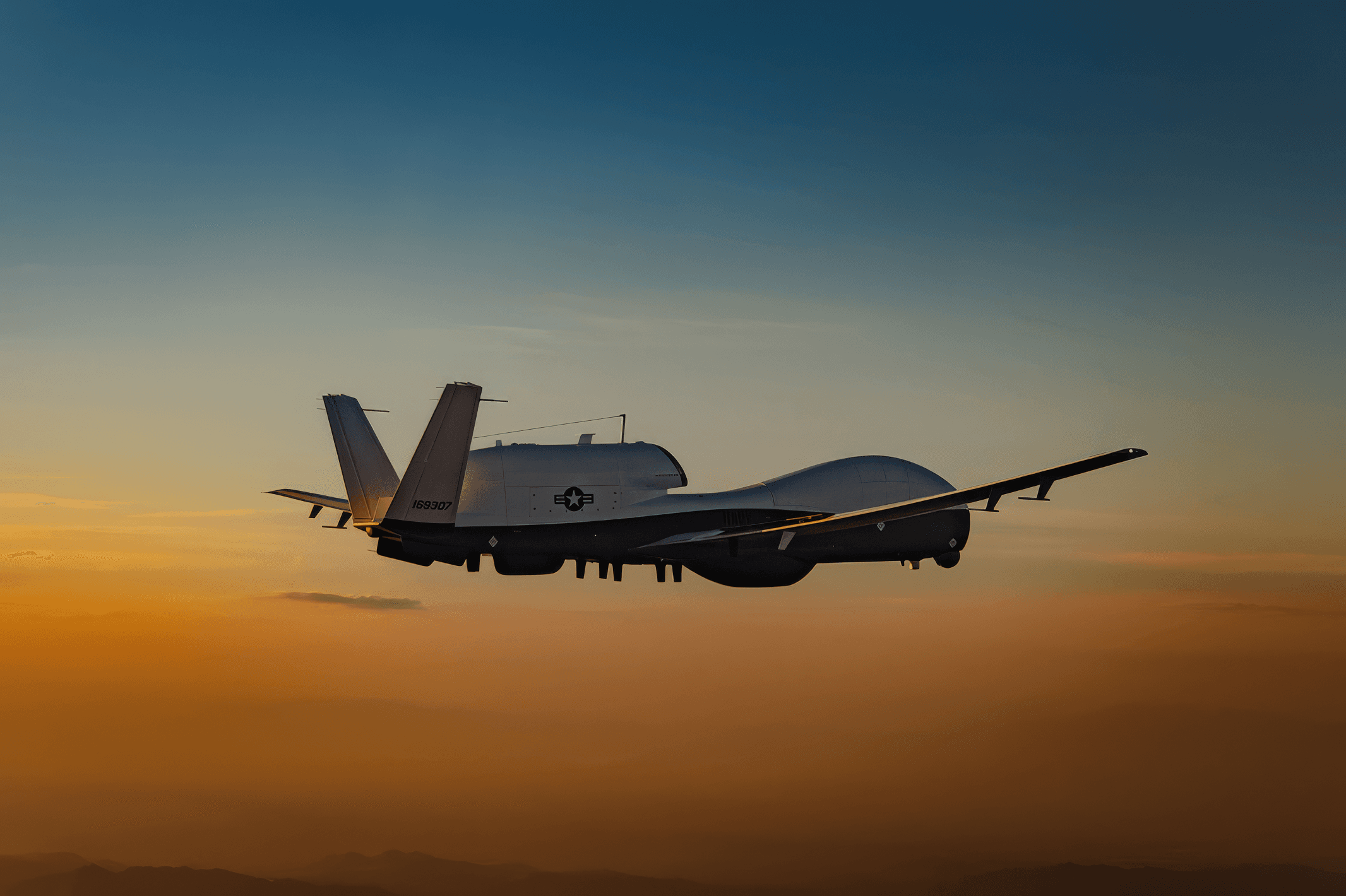 An MQ-4C Triton high-altitude UAV in flight at sunset