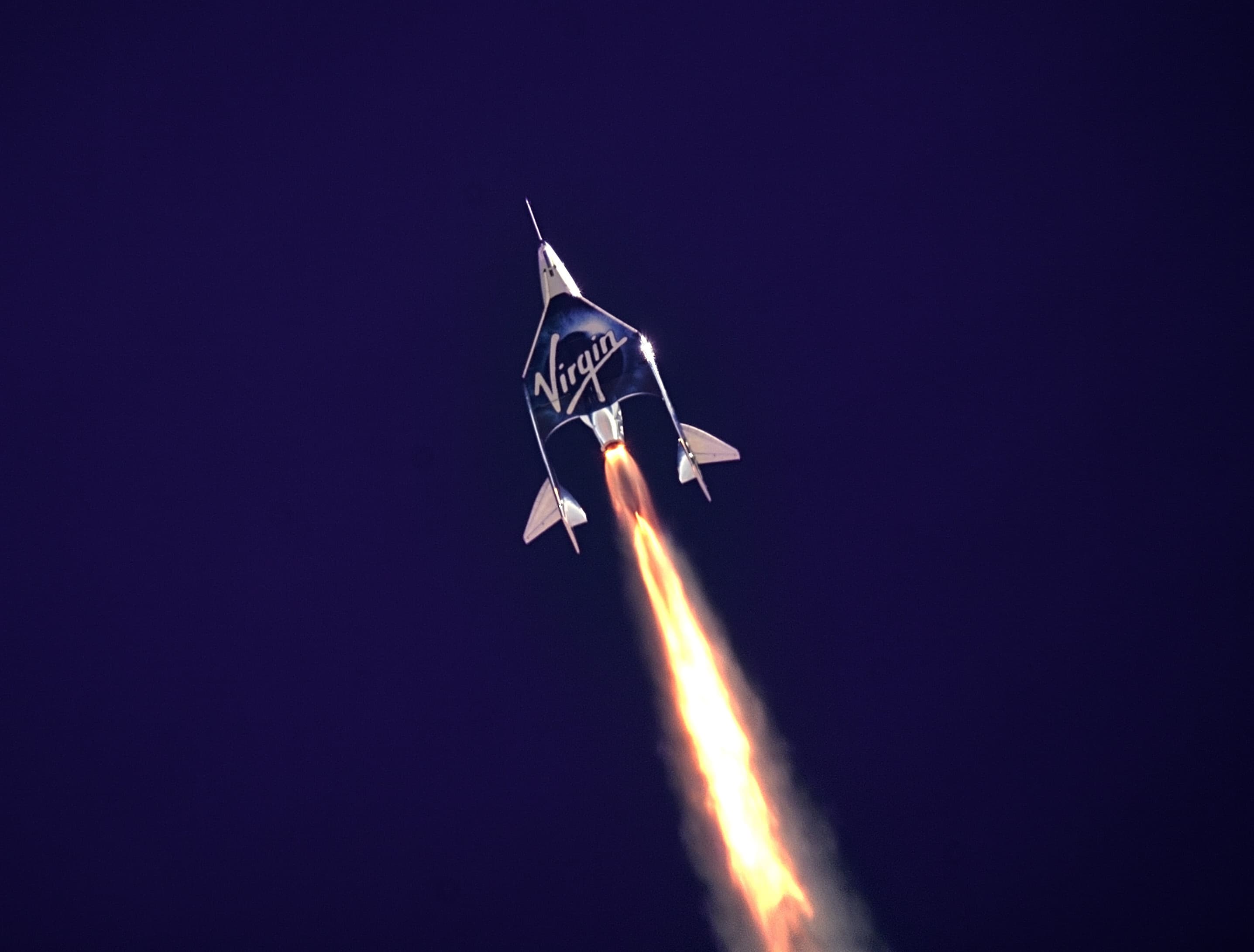 A photograph of the launch of the spacecraft used in Virgin Galactic's Unity 22 sub-orbital spaceflight mission.