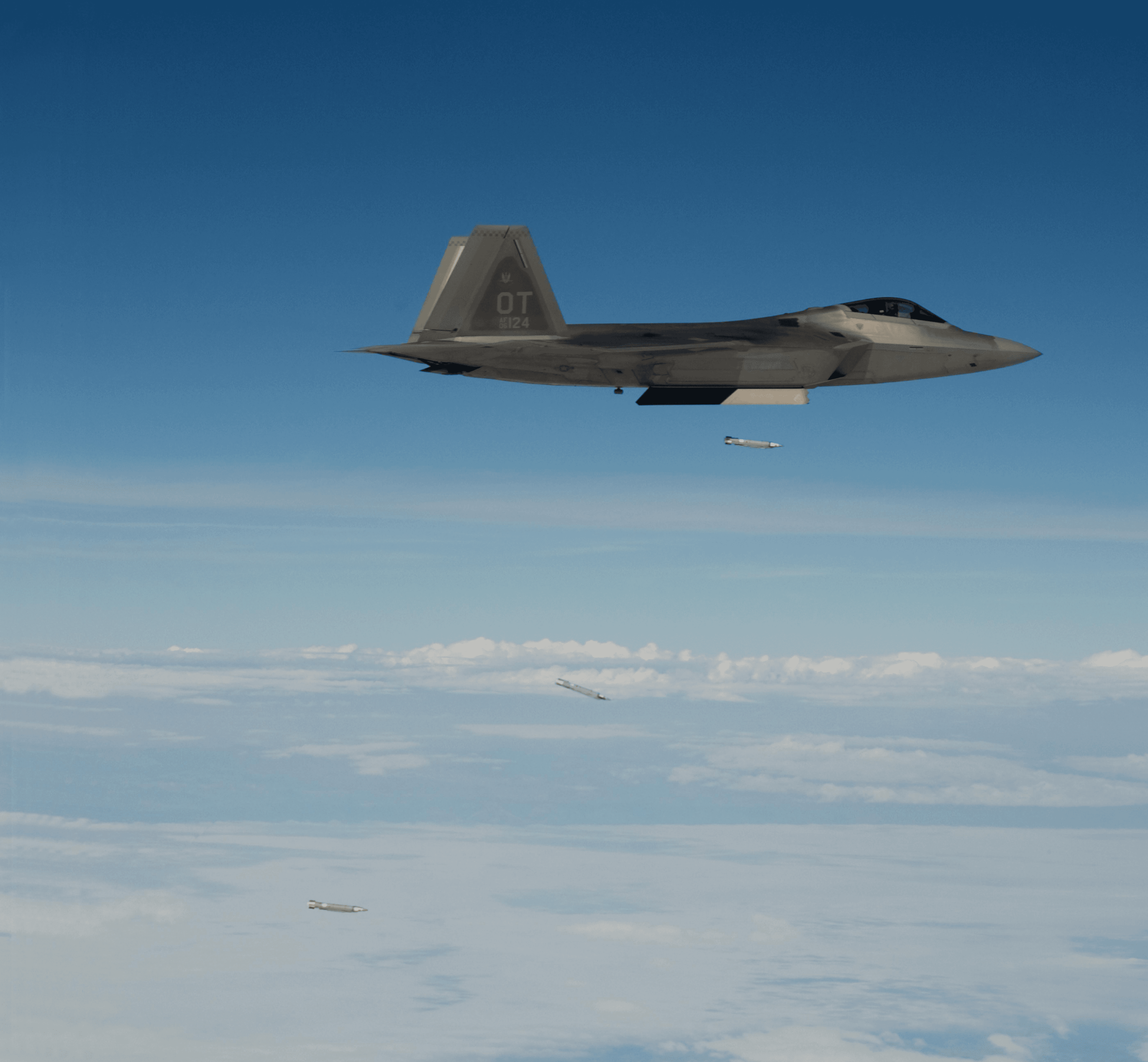 An F-22 Raptor at altitude above a cloud deck